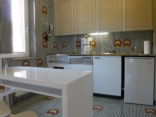 サンモリッツにあるアパートメント　スカイライン　サン モリッツ　バートのキッチン(白いカウンタートップ、電化製品付)