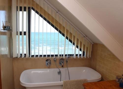 A bathroom at Baby Whale Bliss - Beachfront House