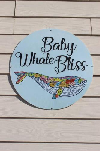 a sign that says baby whale bites with a fish at Baby Whale Bliss - Beachfront House in Witsand