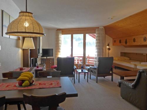 a living room with a table with bananas on it at Apartment Eiger Residence Apt-A-425 by Interhome in Wengen