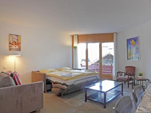 Кровать или кровати в номере Apartment Eiger Residence Apt-H by Interhome