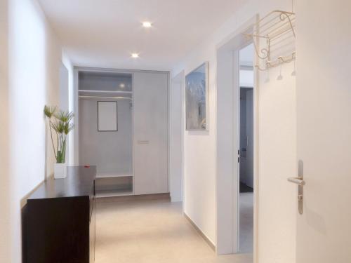 a hallway with a door leading into a room at Apartment Eiger Residence Apt-H by Interhome in Wengen