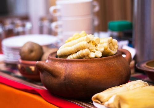 a brown pot filled with food on a table at Laramani Hotel Boutique in Cusco