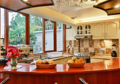 a kitchen with two baskets of fruit on a counter at Laramani Hotel Boutique in Cusco