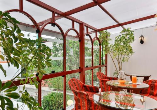 a patio with tables and chairs and plants at Laramani Hotel Boutique in Cusco