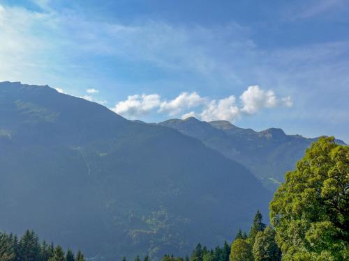 a view of a mountain range with trees in the foreground at Apartment Racer's Retreat Apt-12 by Interhome in Wengen
