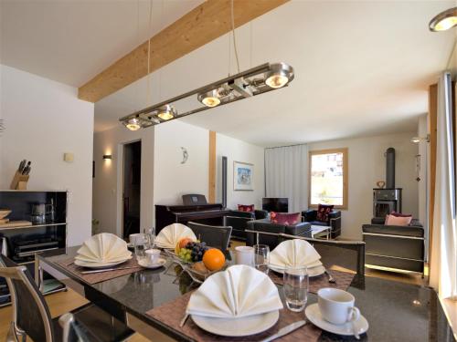 a dining room with a table and a living room at Apartment Chesa Lej by Interhome in Pontresina