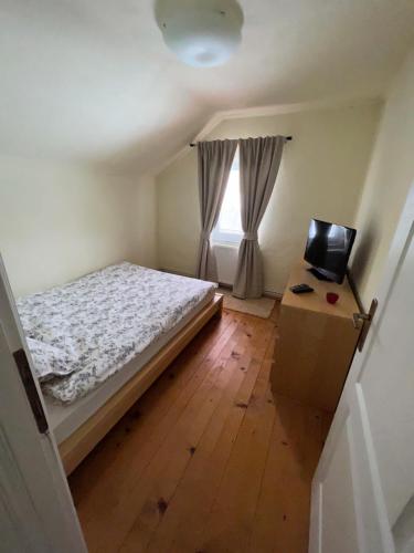 a small bedroom with a bed and a window at Kuća za odmor IVKOVIĆ in Kupres