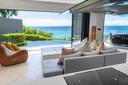 a living room with a couch and a view of the ocean at Tamarind Hills Resort & Villas in Johnsons Point