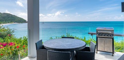 a patio with a table and a view of the ocean at Tamarind Hills Resort & Villas in Johnsons Point