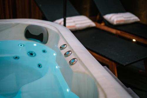 a bathtub in a room with a bed at The Den - The White House Windermere in Bowness-on-Windermere