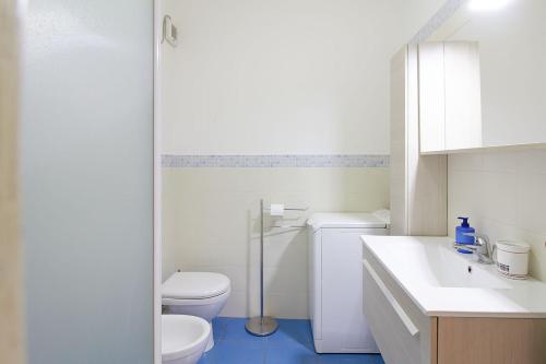 a white bathroom with a toilet and a sink at Appartamenti Di Edo in Finale Ligure