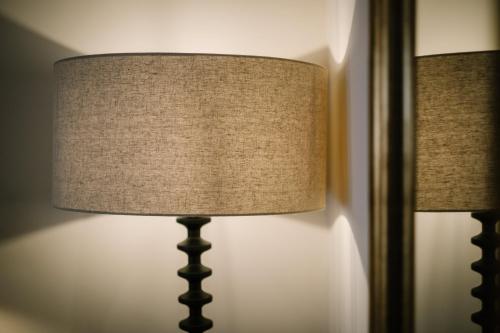 a lamp sitting next to a mirror in a room at The Den - The White House Windermere in Bowness-on-Windermere