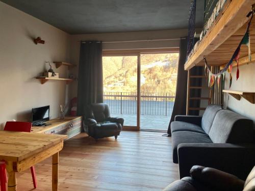 a living room with a couch and a table at Alpi Azzurre in Limone Piemonte
