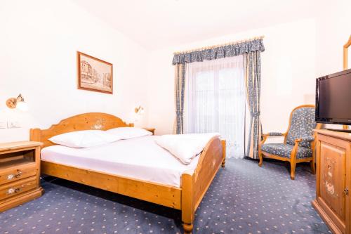 Кровать или кровати в номере Hotel Restaurant Putzer