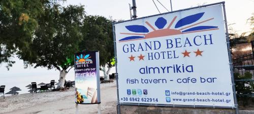 a sign for a grand beach hotel with a sign at Thassos Hotel Grand Beach in Limenaria