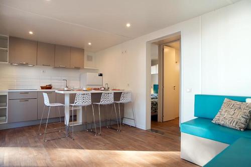 a kitchen with a table and chairs in a room at Camping Europa in Capoliveri