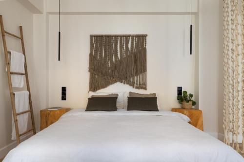 a bedroom with a large white bed and a window at K-Houses A1 in Arta