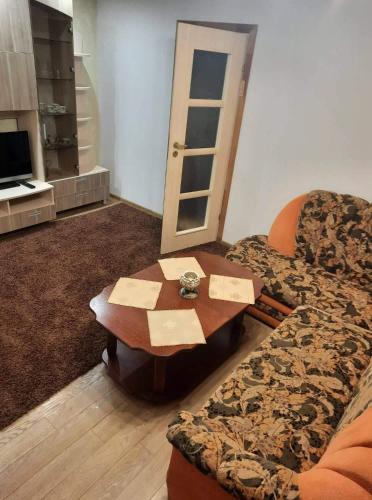 a living room with a couch and a table at Maironio Apartamentai in Radviliškis