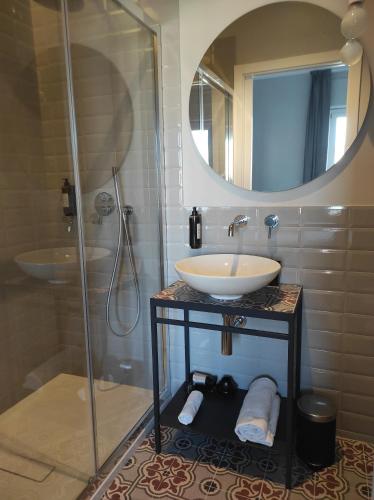 a bathroom with a sink and a shower with a mirror at Residenza Montebello in Ancona