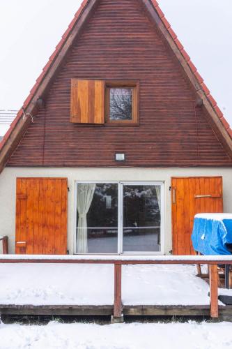 a house with sliding glass doors in the snow at Villa Teodora in Kopaonik