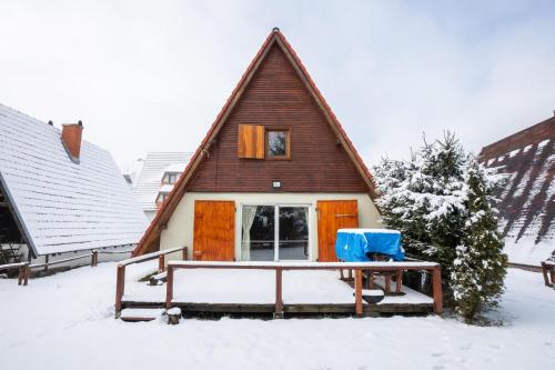 a house with a gambrel roof in the snow at Villa Teodora in Kopaonik