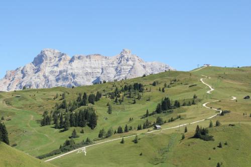 a winding road in front of a mountain at Appartamenti Dany in Arabba