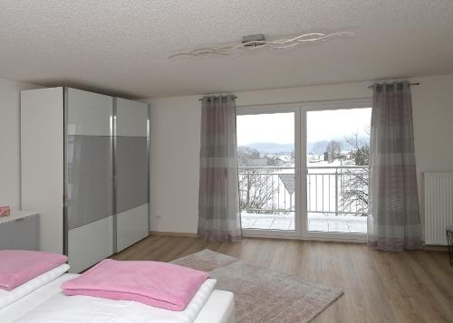 a bedroom with two beds and a large window at Fewo Gabi 2 in Neuschönau
