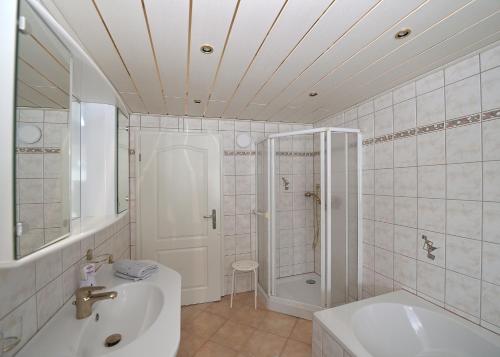 a white bathroom with a sink and a shower at Fewo Gabi 2 in Neuschönau
