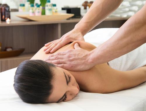 a woman getting a massage from a therapist at Novotel Sofia in Sofia