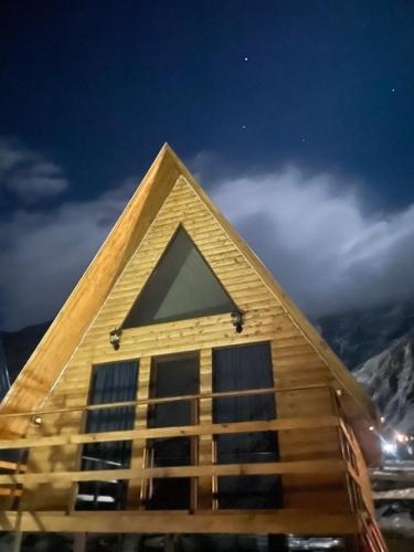 a pyramid shaped building with a triangular roof at AURA Cottages in Stepantsminda