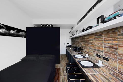 a bathroom with two sinks and a brick wall at Mini Loft ULB DELTA area with terrace in Brussels