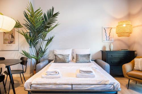 a bedroom with a bed with towels on it at The Beach apartments by Daniel&Jacob's in Copenhagen