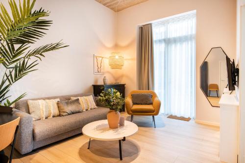 a living room with a couch and a table at The Beach apartments by Daniel&Jacob's in Copenhagen