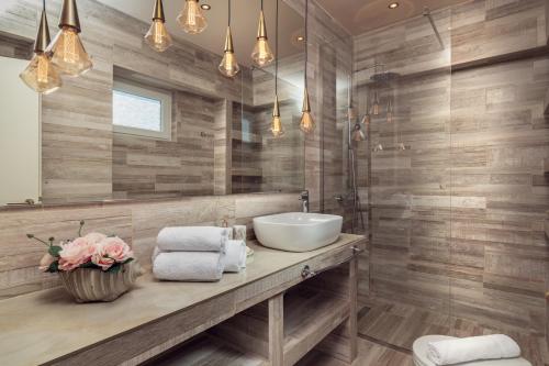 a bathroom with a sink and a mirror at Maison Downtown Luxury Apartments! in Zakynthos Town