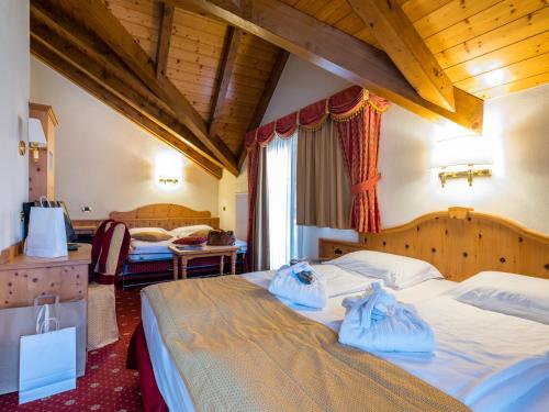 Una cama o camas en una habitación de Albergo Dimaro Wellness Hotel