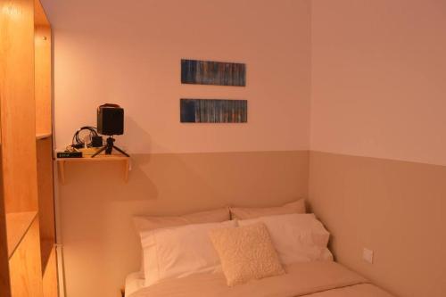 a bedroom with a bed with white pillows at Luxurious Japandi Loft in Ptolemaida
