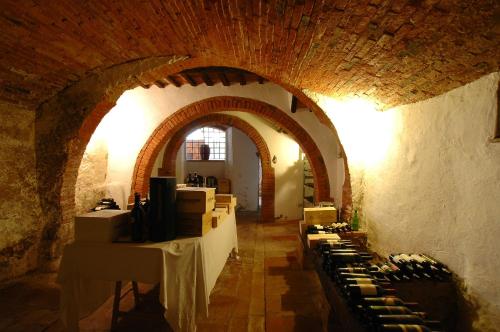 a wine tasting room with a bunch of wine bottles at Palazzo Bizzarri in Rapolano Terme