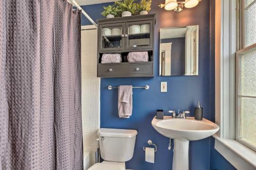 een blauwe badkamer met een toilet en een wastafel bij Stunning Alabama Studio about 2 Mi to Dtwn Mobile! in Mobile