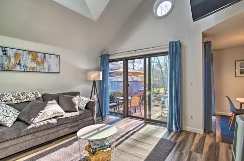 a living room with a couch and a table at 5 Mi to Mashpee Commons Coastal Mashpee Condo in Mashpee