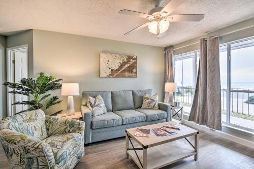 a living room with a couch and a table at Gulf Views and Resort Perks Walkable Galveston Gem in Galveston