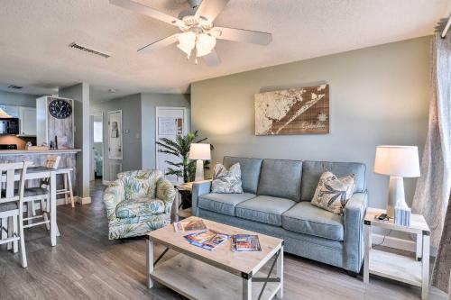 a living room with a couch and a table at Gulf Views and Resort Perks Walkable Galveston Gem in Galveston