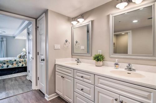 a bathroom with two sinks and a large mirror at Condo with Spacious Balcony - 1 Block to Beach! in Ocean City