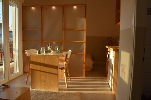 a kitchen with a table and chairs in a room at Luxurious Japandi Loft in Ptolemaida