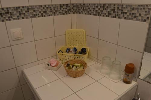 a kitchen counter with a basket of food and bottles at Luxurious Japandi Loft in Ptolemaida