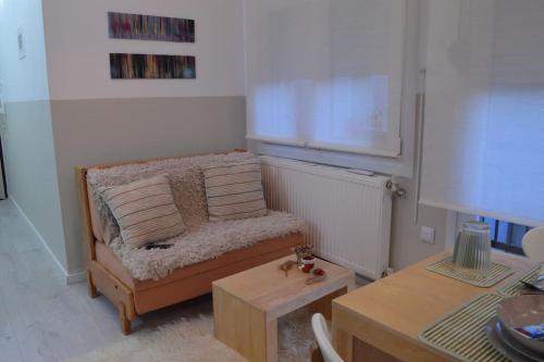 a living room with a couch and a table at Luxurious Japandi Loft in Ptolemaida