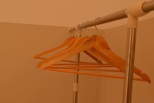 a wooden hanger hanging from a ceiling at Luxurious Japandi Loft in Ptolemaida