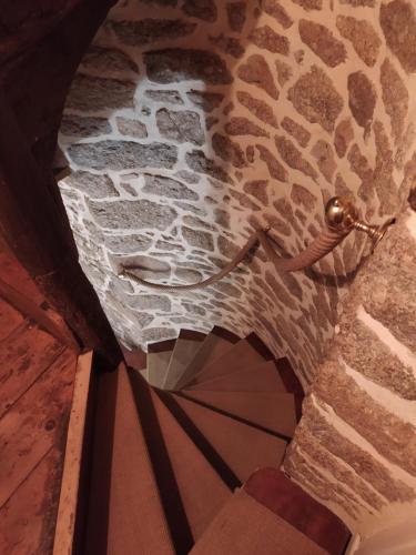 a view from the top of a room with a stone wall at Le séchoir Moncontour in Moncontour