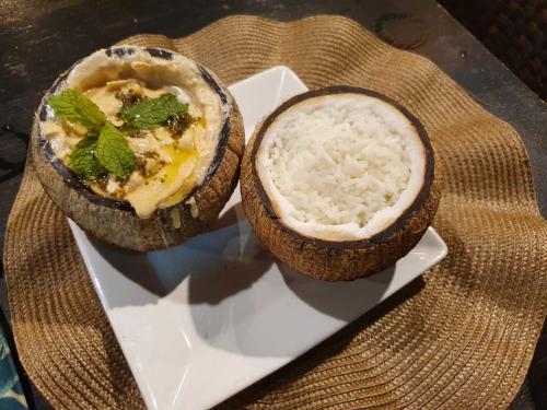 two bowls of food on a plate with rice at Espetacular Casa de Charme em São Miguel do Gostoso - Salou in São Miguel do Gostoso