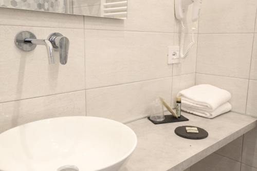a bathroom with a white toilet and a sink at Cadorna Luxury Hotel in Milan